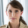 Headshot of woman in tan shirt