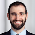 Male with glasses smiling headshot